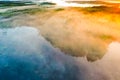 Golden sunrise over green forest, aerial landscape. Bright morning. Lakes and woods in fog Royalty Free Stock Photo