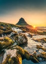 Golden sunrise over Kirkjufell mountain with waterfall flowing in summer at Snaefellsnes, Iceland