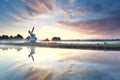 Golden sunrise over windmill reflected in river Royalty Free Stock Photo