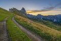 Golden sunrise at Seceda, Dolomites, Italy, A stunning spectacle bathes the rugged landscape and meadows in warm hues