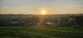 Golden sunrise sunset over paddy rice fields in a village. Mountain and forest view can be seen Royalty Free Stock Photo