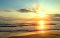 Golden sunrise sunset over the sea ocean waves. Rich in dark clouds, rays of light Royalty Free Stock Photo