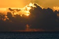 Golden sunrise or sunset over the sea. Rays of the sun shining through clouds. Royalty Free Stock Photo