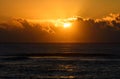 Golden sunrise or sunset over the sea. Sunlight reflects from water waves.