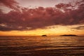 Golden sunset on the beach with dark clouds and evening glow.The sea reflection red light.like sunrise.