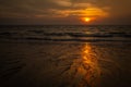 A golden sunset on a beach in Koh Lanta, Thailand, the colour of the sun reflecting on the wet sand Royalty Free Stock Photo