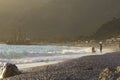 Golden sunset on the beach of the Mediterranean Sea. A yacht is moored at the shore Royalty Free Stock Photo