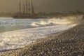 Golden sunset on the beach of the Mediterranean Sea. A yacht is moored at the shore Royalty Free Stock Photo