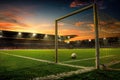 Golden Sunset Behind Soccer Goal Post in an Empty Stadium with Clear Blue Sky and Plush Green Field Royalty Free Stock Photo