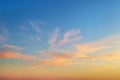 Golden sunset clouds in a clear blue sky. Scenic dusk skyscape. Twilight paradise sky. Calm heaven background