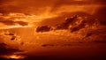 Golden sunset. Evening sky with clouds. Dark orange brown. Fire. Dramatic skies background with space for design. Royalty Free Stock Photo