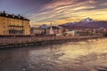 Golden sunset in Innsbruck. Dramatic evening sky in Austria. Innsbuck landmark. River embankment in Tirol.