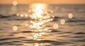 Golden sunset light reflecting on the ocean surface creating a bokeh effect of shimmering circles of light Keywords Royalty Free Stock Photo