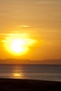 Golden sunset over beach and mountain horizon Royalty Free Stock Photo