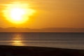 Golden sunset over beach and mountain horizon Royalty Free Stock Photo