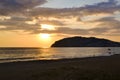 Golden sunset over the Mediterranean Sea. The setting sun shines through the clouds, and a golden path is visible above the ocean Royalty Free Stock Photo