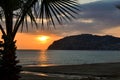 Golden sunset over the Mediterranean Sea. The setting sun shines through the clouds, and a golden path is visible above the ocean Royalty Free Stock Photo