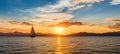 Golden Sunset over Ocean with Sailboat on Horizon, Grandeur and Tranquility of Moment Royalty Free Stock Photo