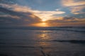 Golden sunset over the sea with beautiful cloudy sky on background. Amazing tranquil scene in soft light colors, copy space Royalty Free Stock Photo