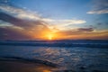 Golden sunset over the sea. Blue waves, bright colorful cloudy sky. Amazing tranquil scene