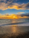 Golden Sunset Over the Sea With Sun Rays and Dramatic Clouds Royalty Free Stock Photo