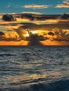 Golden Sunset Over the Sea With Sun Rays and Dramatic Clouds Royalty Free Stock Photo