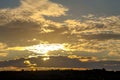 Golden sunset over sunflower fields, mystical clouds in the sky