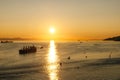 Golden Sunset into the sea with the silhouette of ship