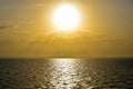 Golden sunset sun over sea. Sun`s rays break through clouds. Magnificent seascape. Royalty Free Stock Photo