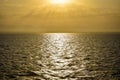 Golden sunset sun over sea. Sun`s rays break through clouds. Magnificent seascape. Royalty Free Stock Photo