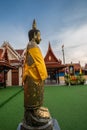 A golden tall Buddha standing at wat Intharawihan.