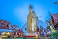 A golden tall Buddha standing at wat Intharawihan.