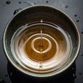 Golden Tea Drop Creating Perfect Ripples Royalty Free Stock Photo