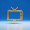 A golden television icon with antenna on blue background casting a soft shadow on the surface Royalty Free Stock Photo