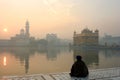 Golden temple with a man in meditation Royalty Free Stock Photo