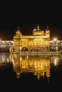 Golden temple with reflection in the water at night Royalty Free Stock Photo