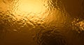 Golden textured surface with reflective metallic appearance Royalty Free Stock Photo