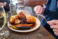 The golden thick crackling on top of roast pork belly on a white plate with roast potatoes and Yorkshire pudding with vegetables Royalty Free Stock Photo