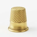 Golden Thimble with Textured Surface on White Background sewing tool Royalty Free Stock Photo