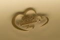 Golden three dimensional word Happy Valentine`s Day in a heart isolated on golden background