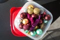 Golden, tiffany and burgundy Christmas balls packed for keeping in a transparent plastic food container on black table Royalty Free Stock Photo