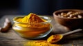 Turmeric powder elegantly poured into a wooden bowl on a table