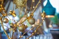 Golden toy balls hanging on artificial tree branches decoration Royalty Free Stock Photo