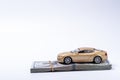 Golden toy car on dollars stack with rubberband Royalty Free Stock Photo
