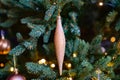 a golden toy icicle on a spruce branch. traditional Christmas decorations. Royalty Free Stock Photo