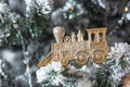 Golden Train Ornament on Snow-Flocked Christmas Tree Royalty Free Stock Photo