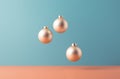 Golden tree baubles spheres floating over the simple pastel background.