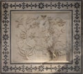Square panel of carved marble with ornate border