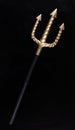 Golden Trident isolated on black Royalty Free Stock Photo
