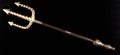Golden Trident isolated on black Royalty Free Stock Photo